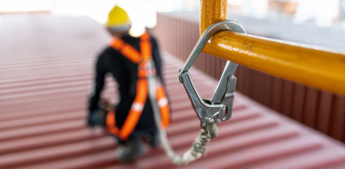 Construction worker wearing safety harness and safety line worki