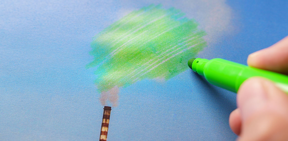 Man painting green pollution from a chimney