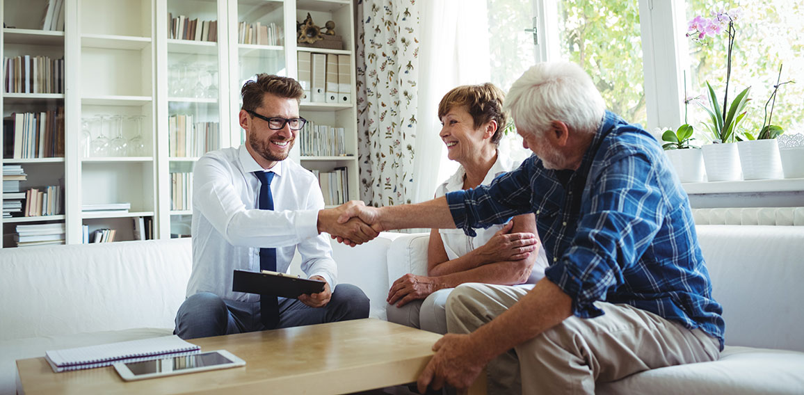 Financial advisor shaking hands with senior man