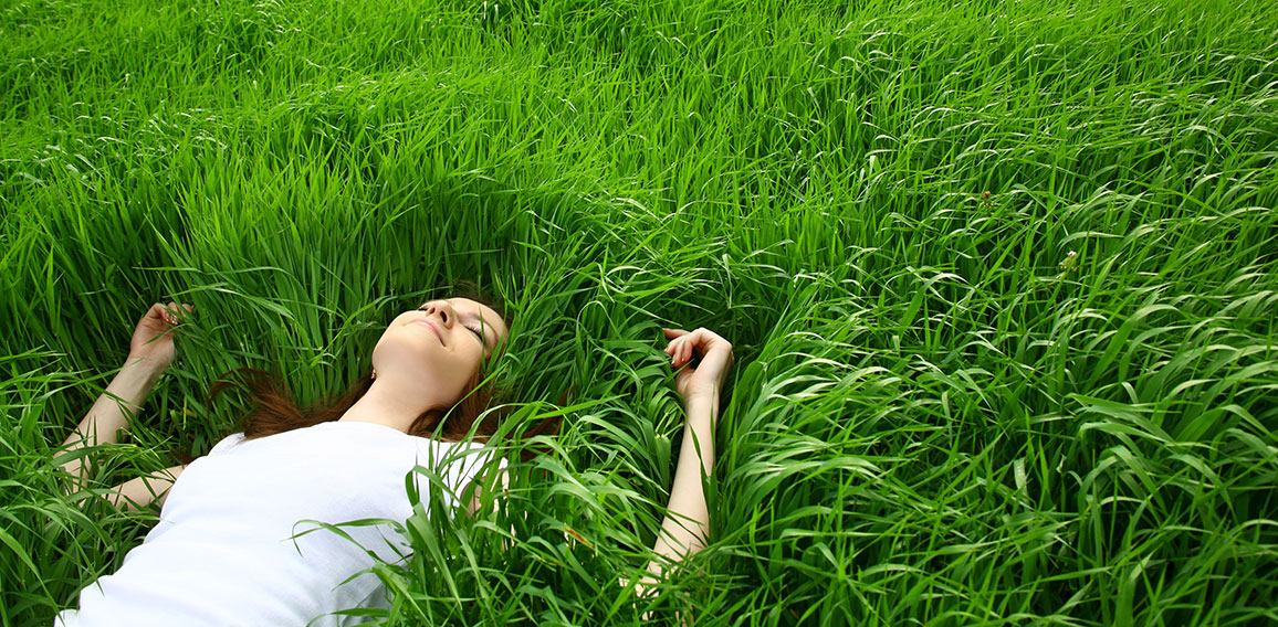 beautiful girl lying down of grass