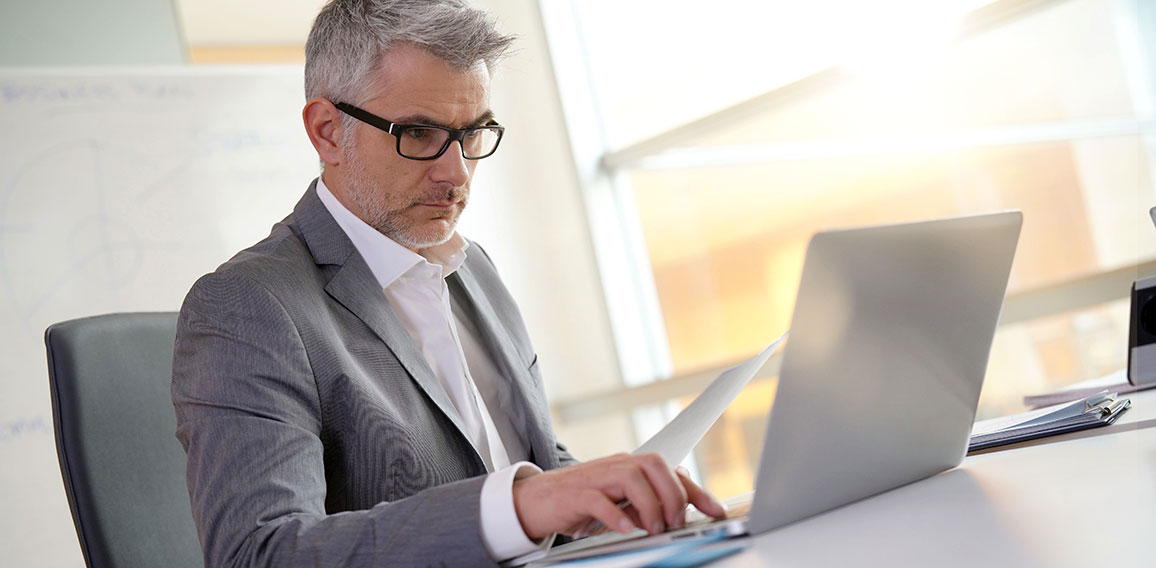 Businessman in office working on laptop