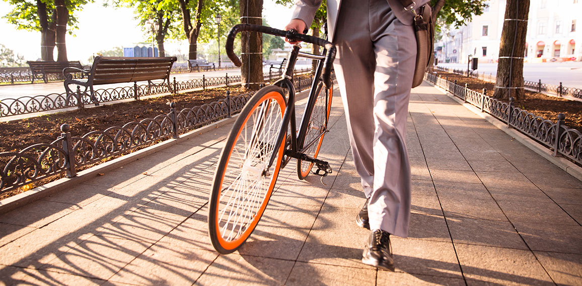 businessman walking with bicycle