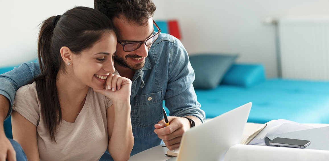 Husband and wife sitting at home and buying online stocks action