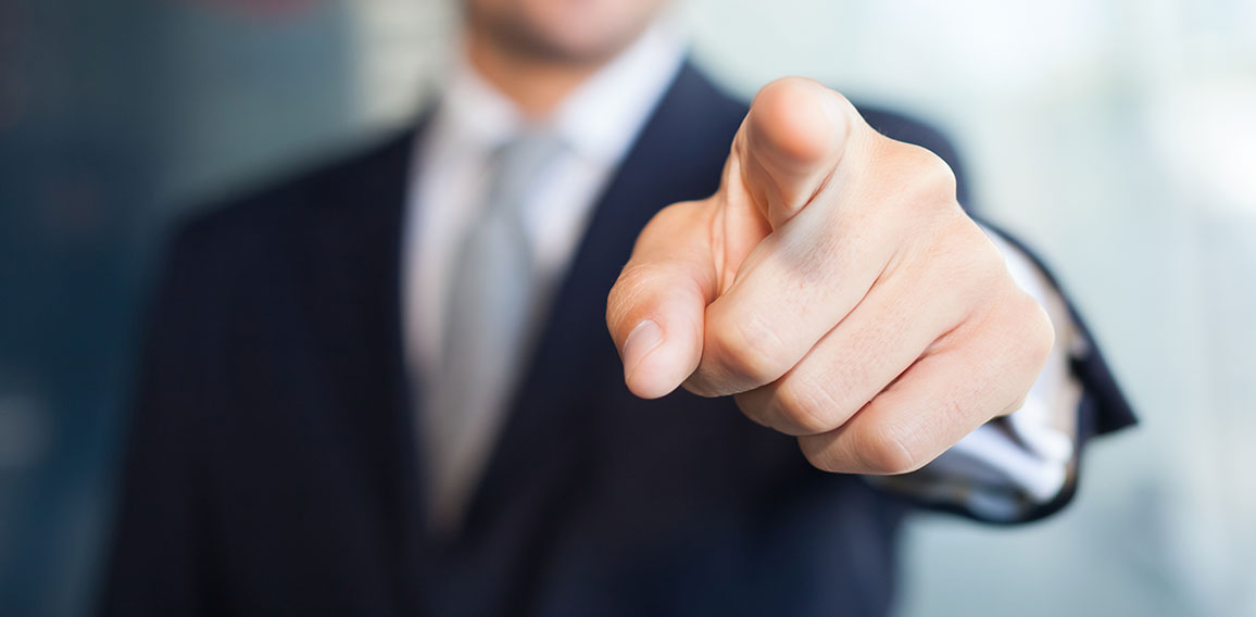 Businessman pointing his finger at you