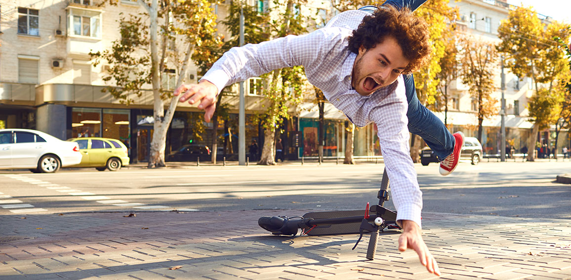 Accident with an electric scooter. A man fell from a scooter on a city street.