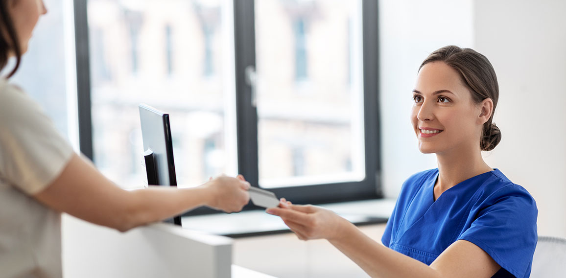 doctor and patient with credit card at hospital