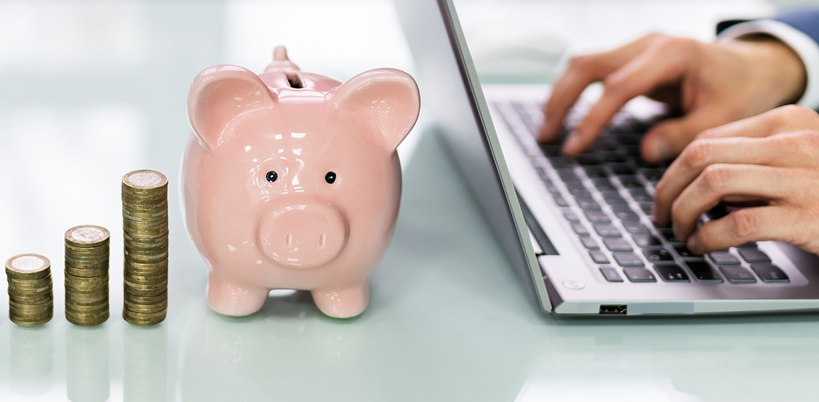 Piggy Bank And Increasing Coins Stack On Desk