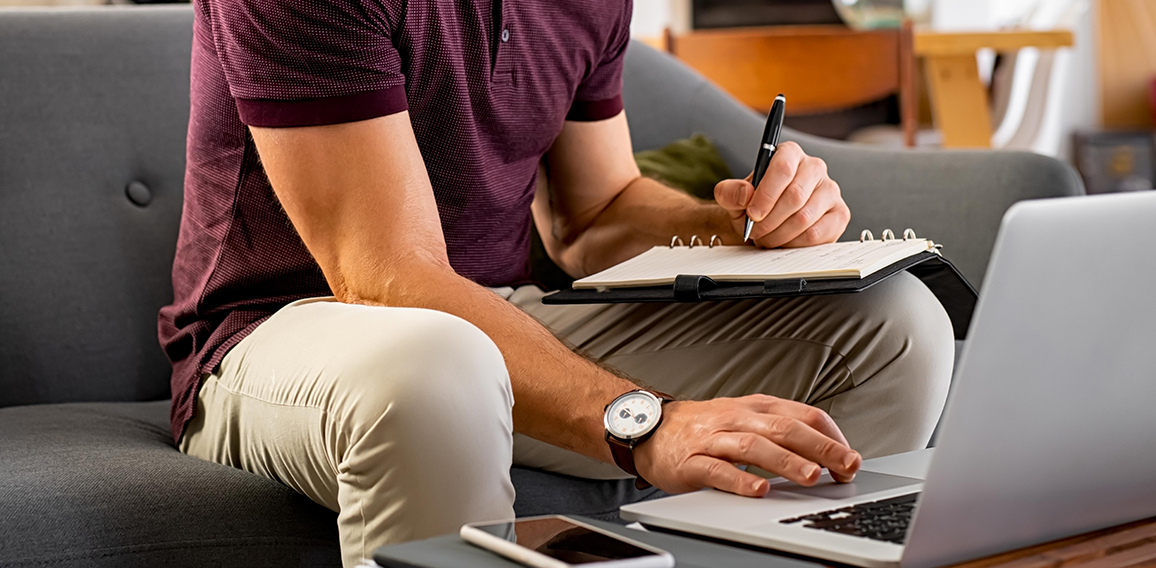 Busy businessman working on laptop at home