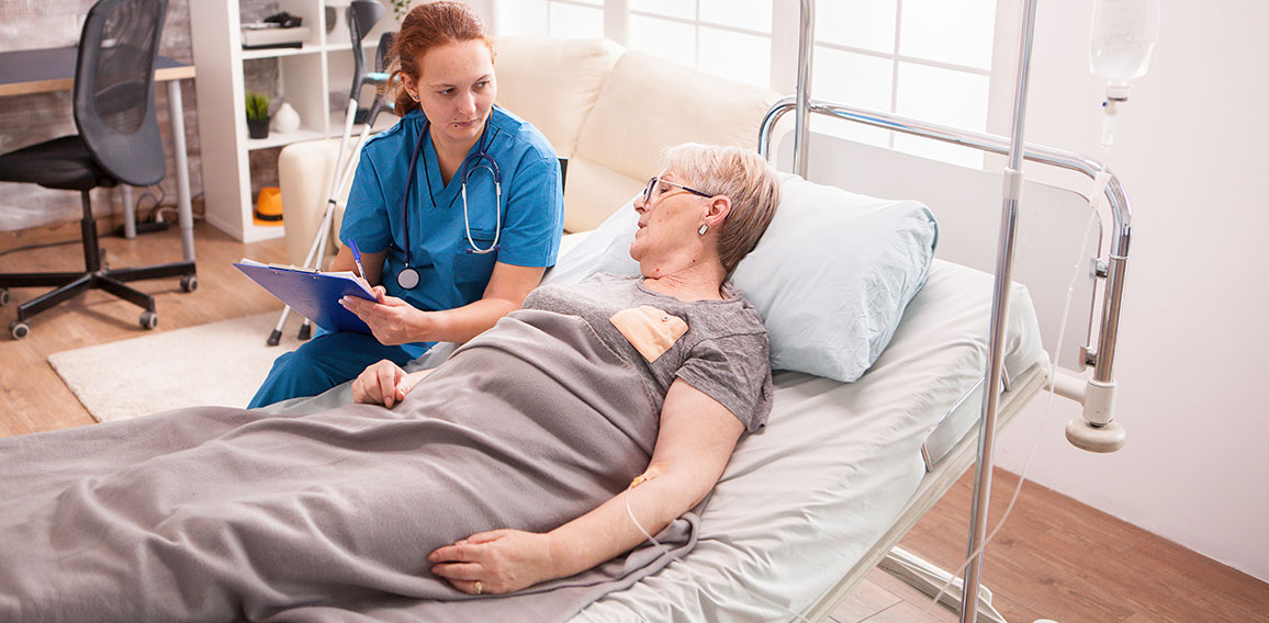 Senior woman lying in nursing home bed