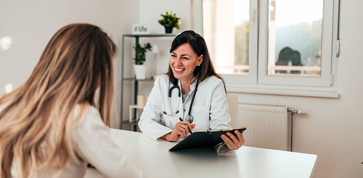 Young doctor and patient talking in the doctor's office.