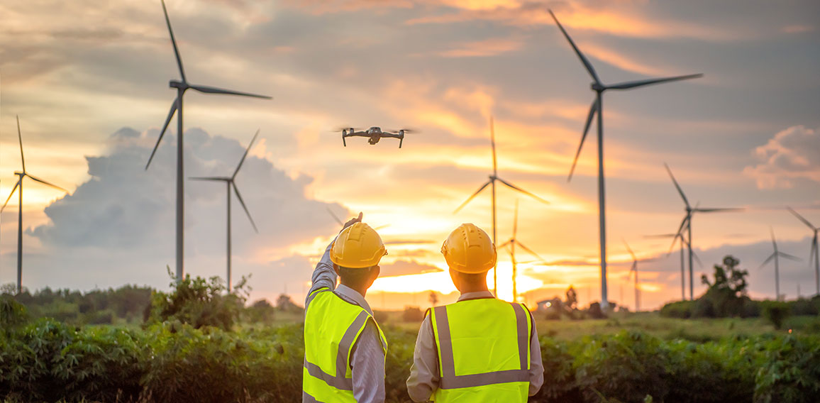 two asian engineers male flying drone surveying and checking win