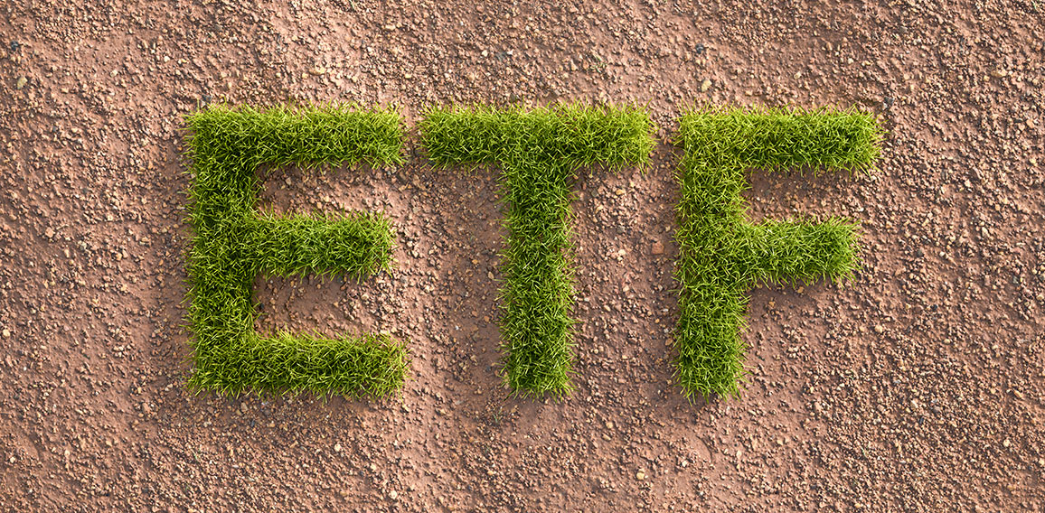 Green grass letters ETF in an arid landscape. Concept for  Exchange traded funds investing by ESG standards (environment social governance).