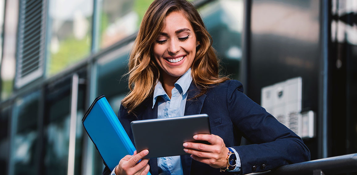 Young businesswoman working with tablet outdoor. Business, educa