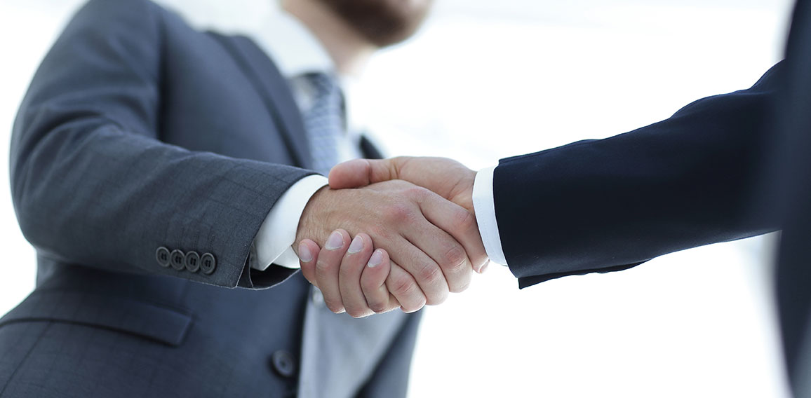 Successful business people handshaking after good deal.