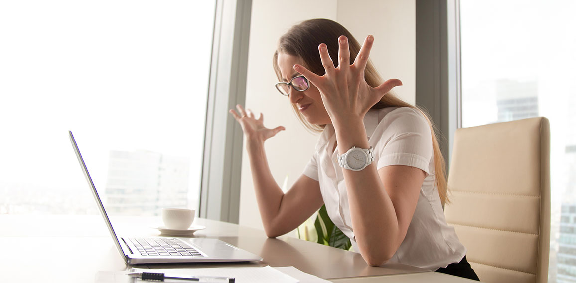 Angry businesswoman having problem with computer, broken laptop,