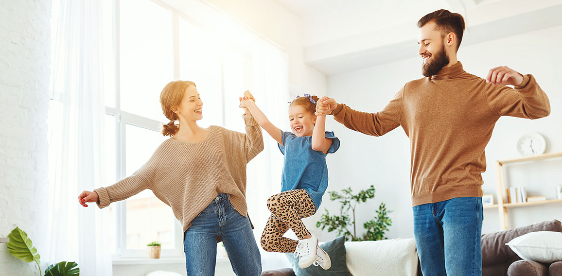 happy family mother father and child daughter dancing at home