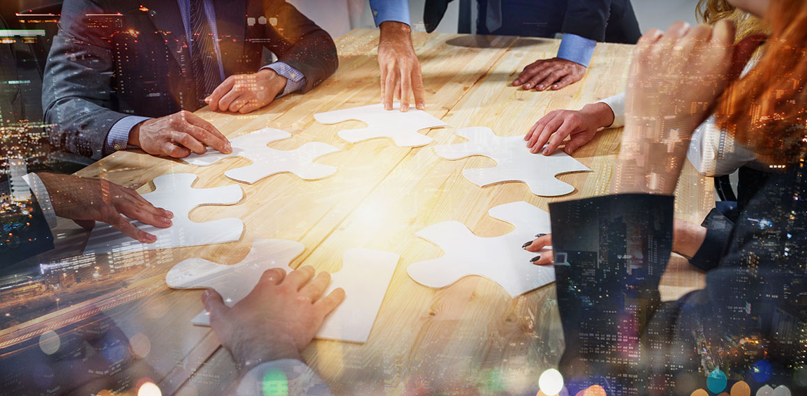 Teamwork of partners connect puzzle pieces as integration and startup