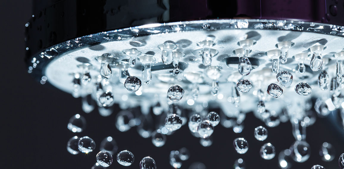 Shower Head with Water Stream on Black Background