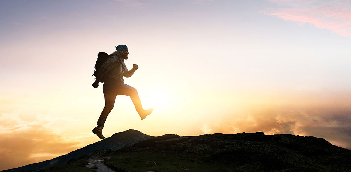 Male backpacker walking in mountains