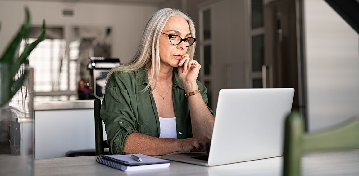 Worried senior woman using laptop