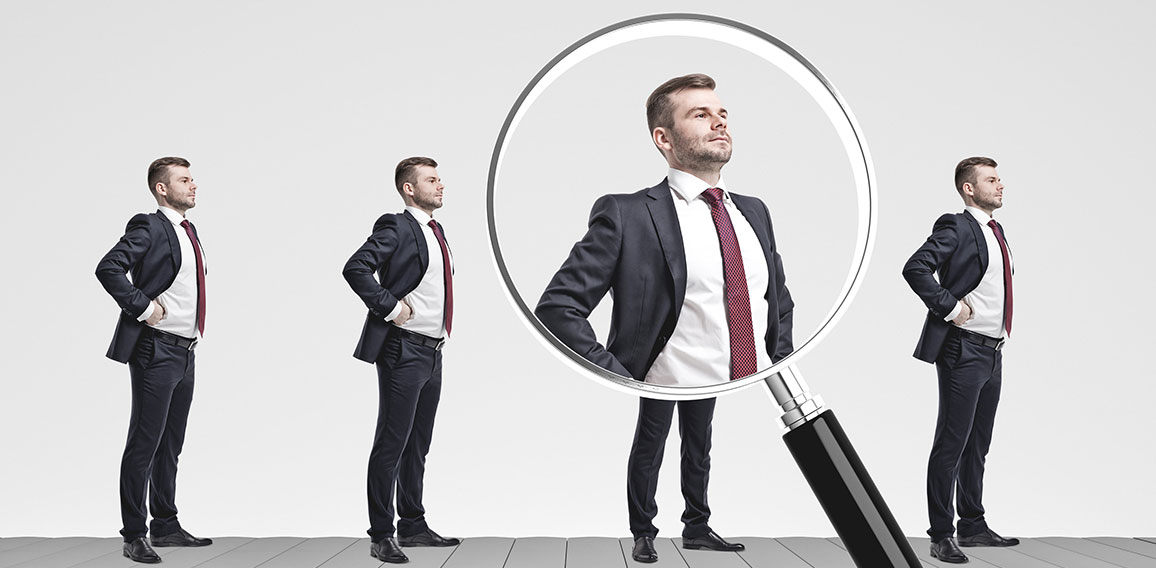 Businessmen on conveyor, magnifying glass