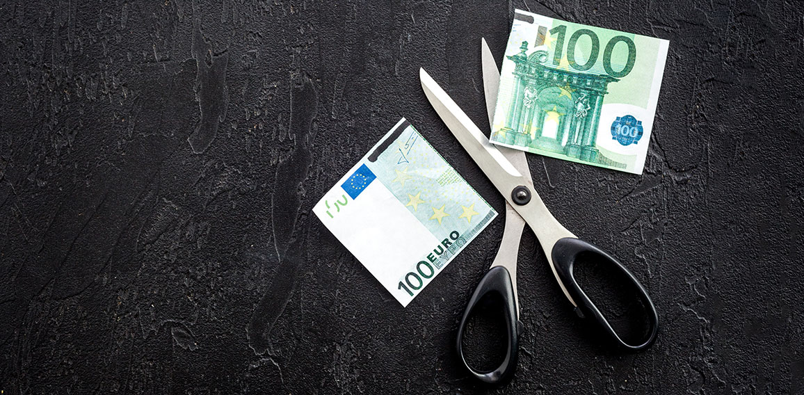 Decline of euro exchange rate. Scissors cut dollars banknote