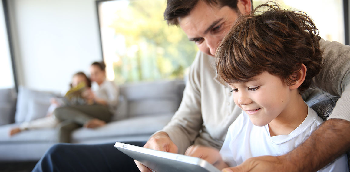 Father and son playing with digital tablet