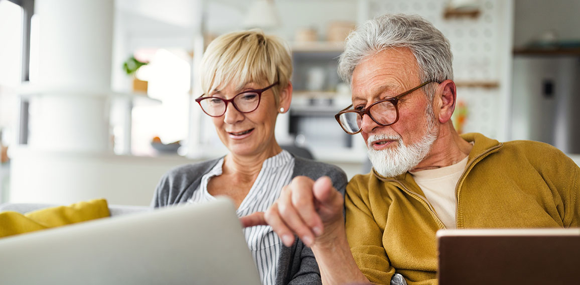 Happy romantic senior couple hugging and enjoying retirement at home