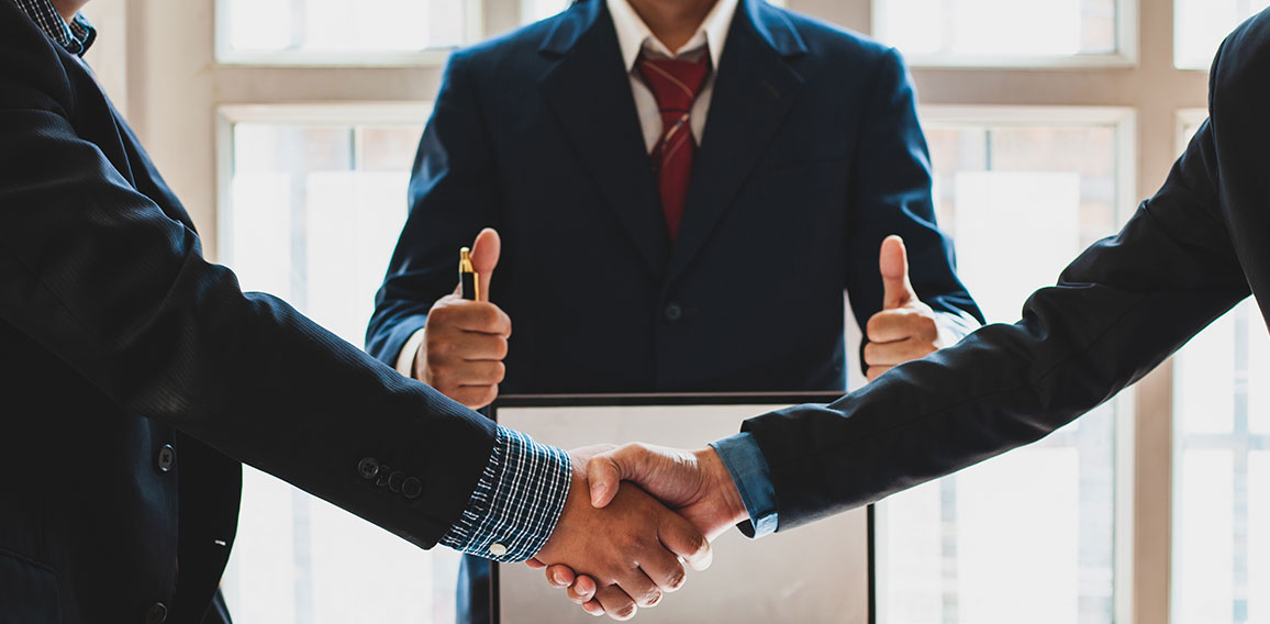 Business people shake hands while negotiating a business deal. C