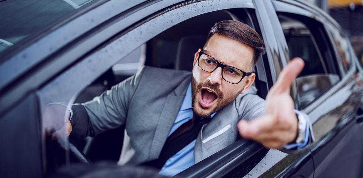 A sharp dressed man finding himself caught in a rush hour and sl