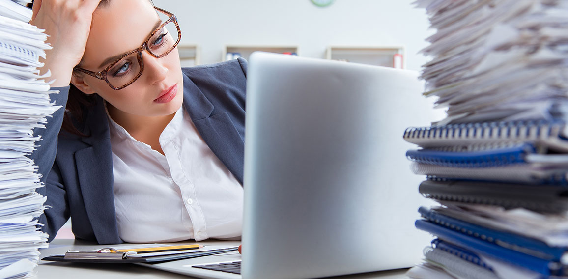 Tired businesswoman with paperwork workload