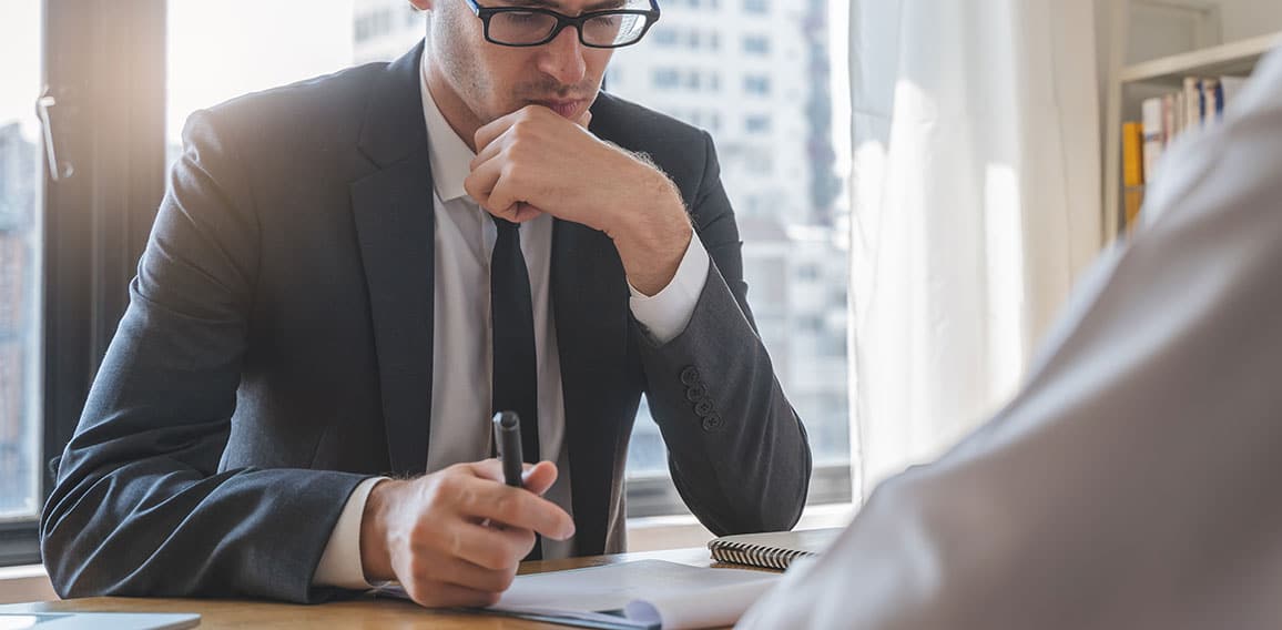 interviewer on the table asking question applicant in the office