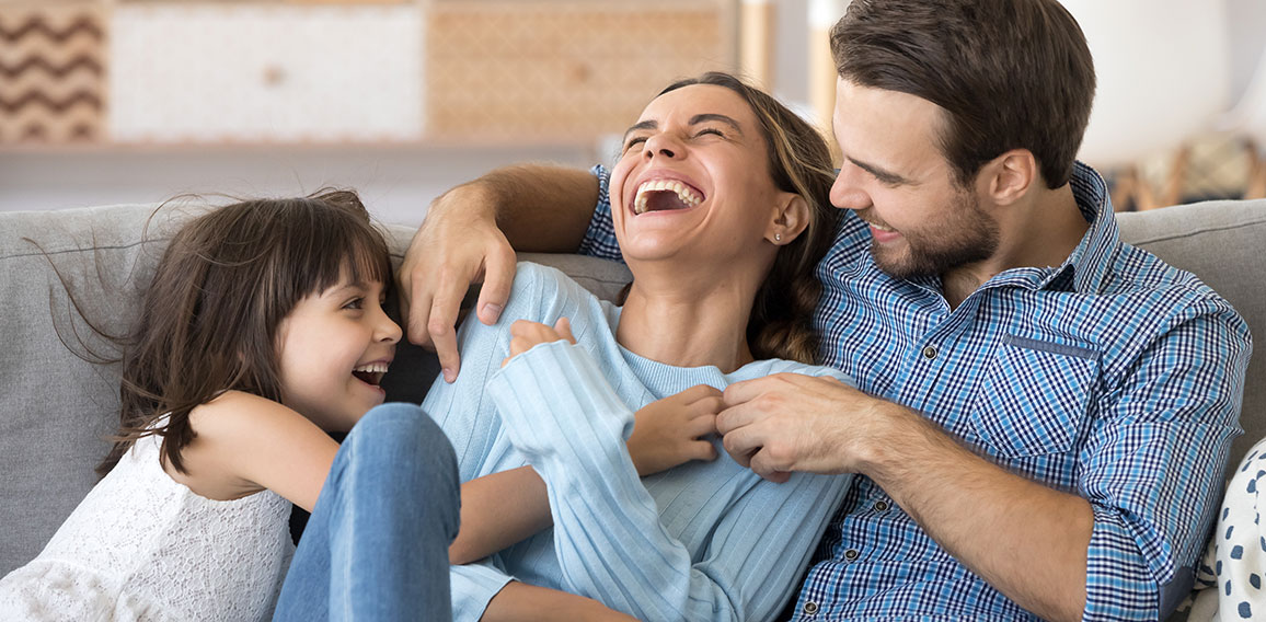 Family have fun daughter and daddy tickling mother