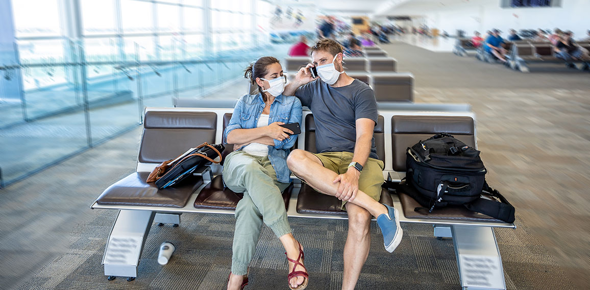 Coronavirus outbreak travel restrictions. Traveler with mask at