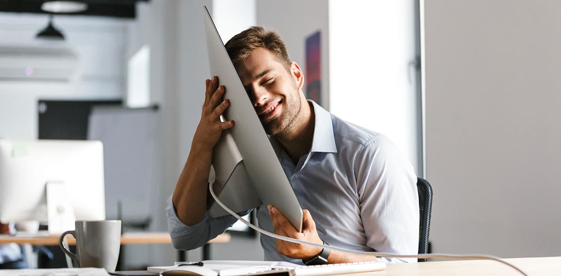 Pleased male manager having fun with computer