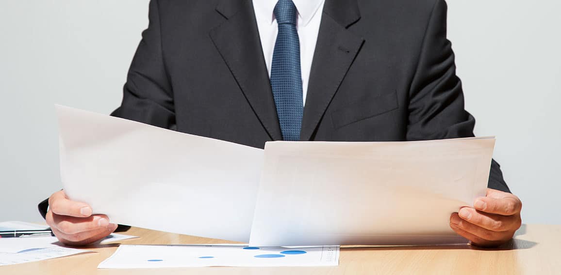 Businessman comparing two documents