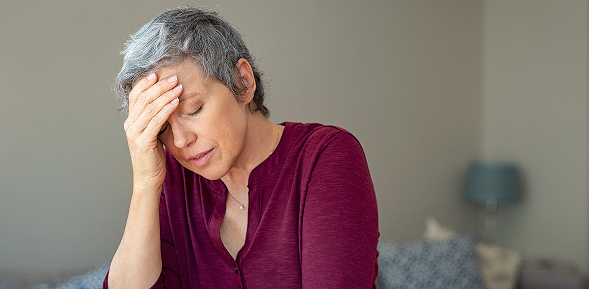 Stressed senior woman at home