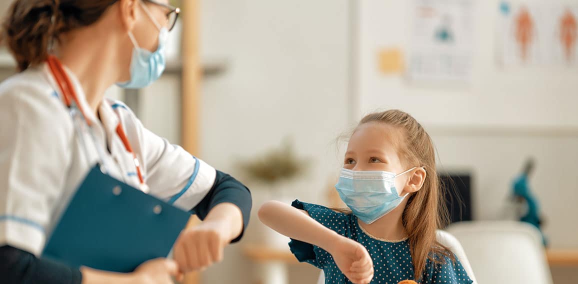 Doctor and child wearing facemasks