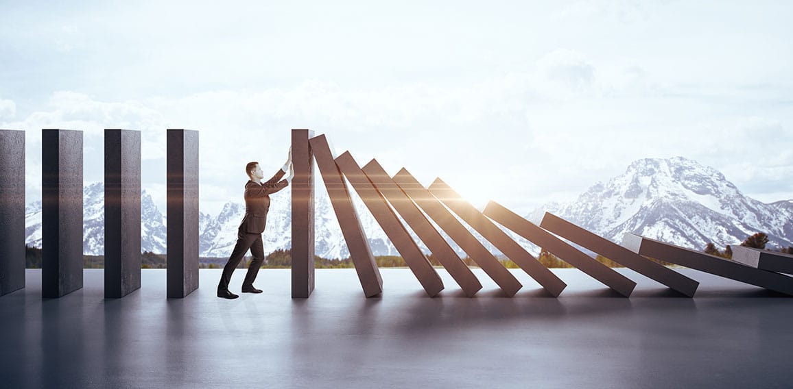 Businessman in suit pushing blocks