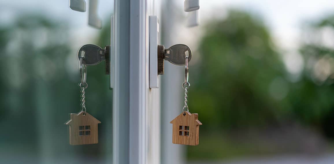 The wooden house key is inserted at the door of the house. There