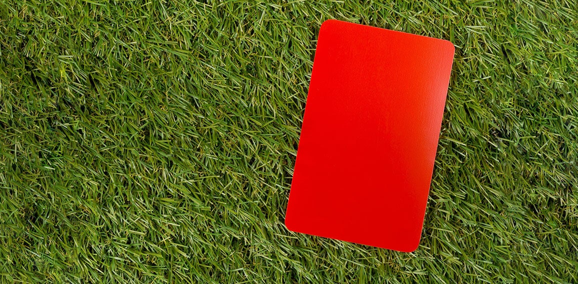 Soccer sports referee red cards on grass background flat lay fro