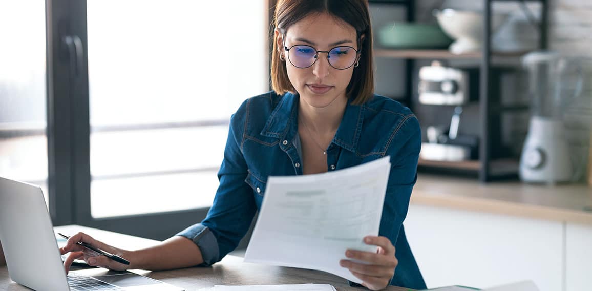 Pretty young business woman working with computer while consulti