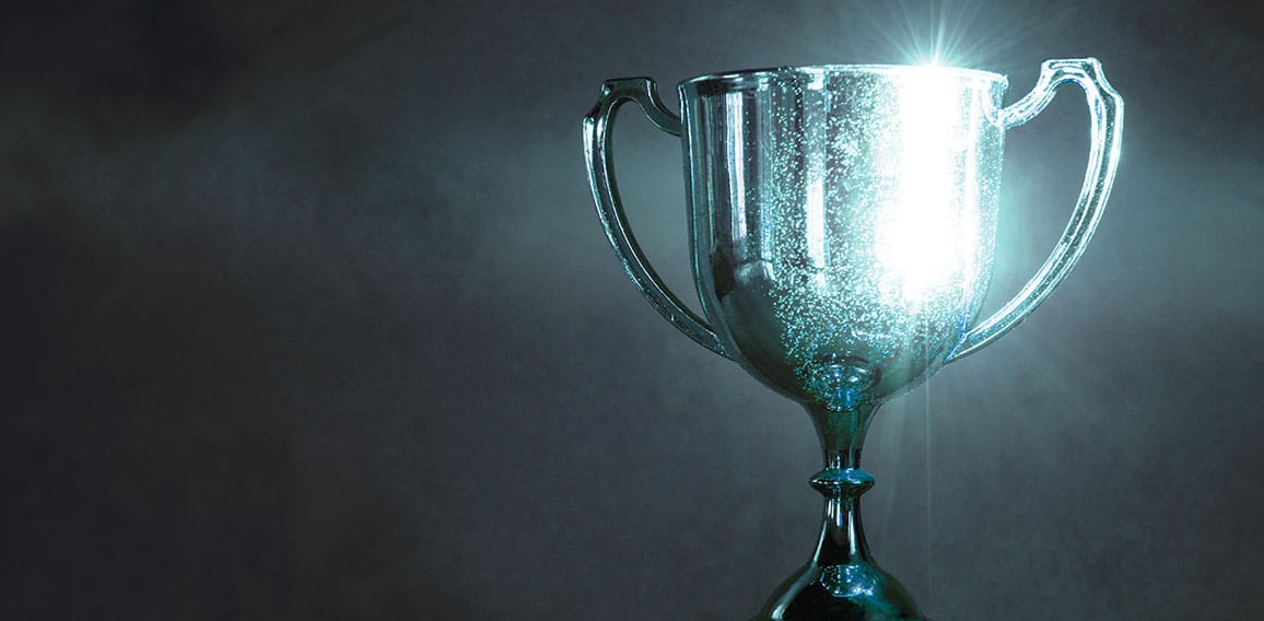 champion golden trophy placed on wooden table