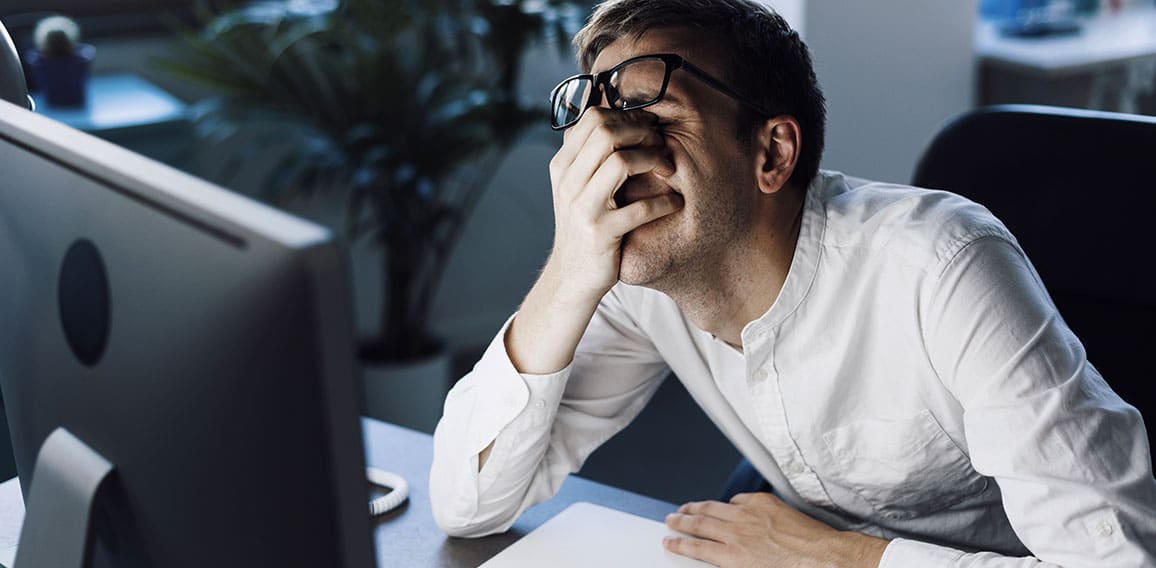 Panicked businessman having issues with his computer