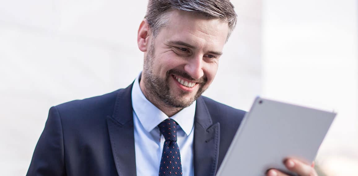 Happy businessperson with tablet