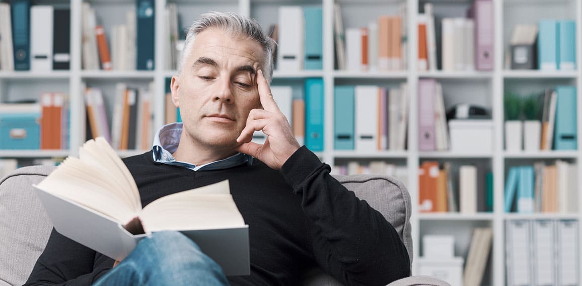 Man relaxing and reading a book