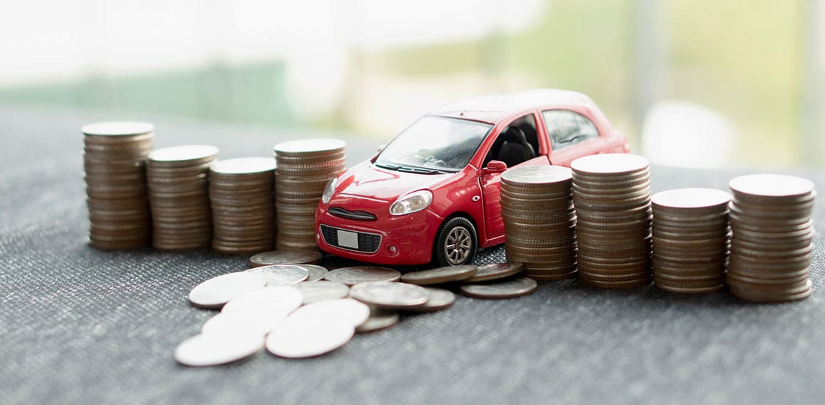 red car over a lot of stacked coins