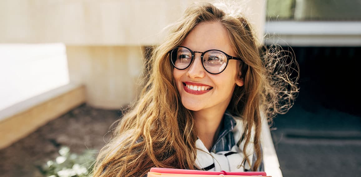 Closeup portrait of a smiling young student woman wearing transp