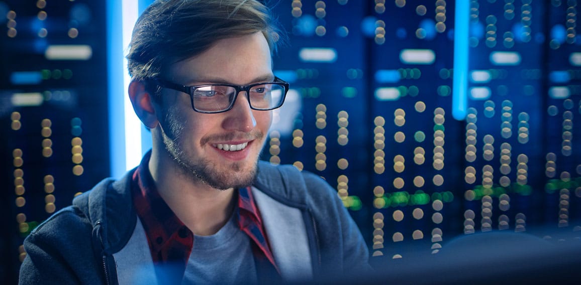 Portrait of Smart SmilingFocused Young Man Wearing Glasses Worki