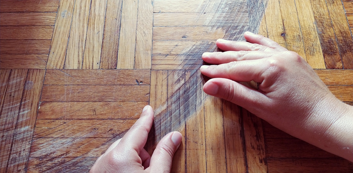 Old scratched surface of hardwood flooring in need of maintenance. parquet ruined by scratches made by prolonged use of chair.